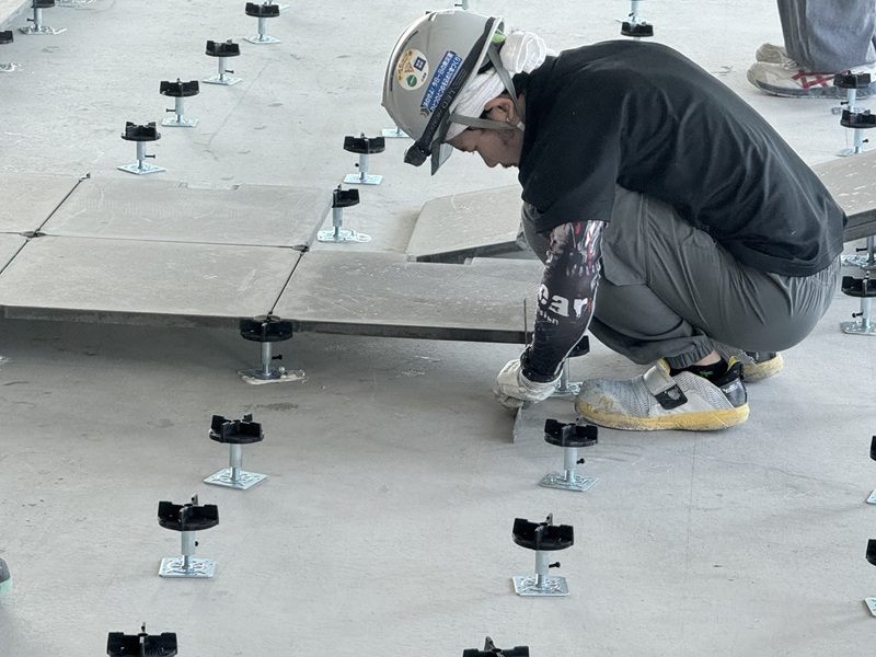 Workers are installing the raised access floors
